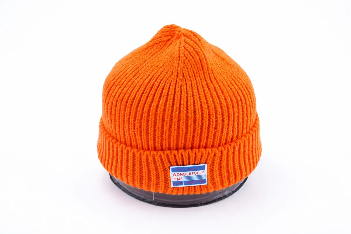 Orange rib-knit cuffed beanie with front label