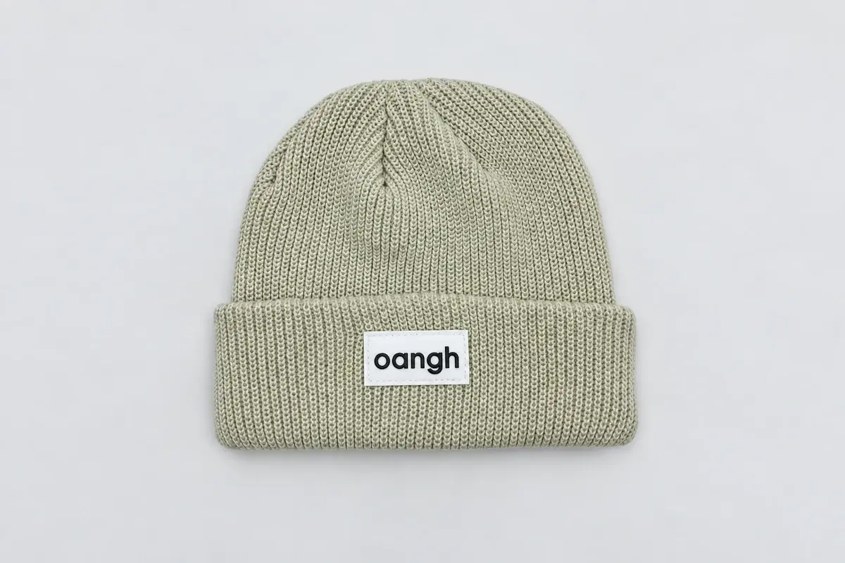 Light gray-green rib-knit cuffed beanie with woven front patch