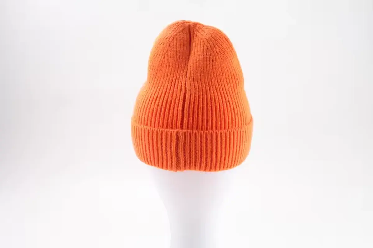 Orange rib-knit beanie with a folded cuff.