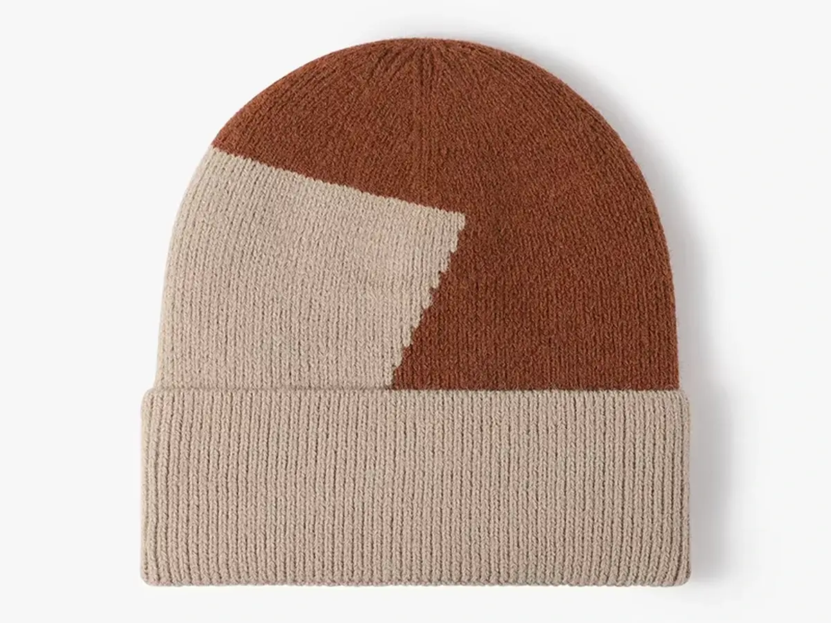 Two-tone cream and caramel rib-knit beanies with folded cuffs.