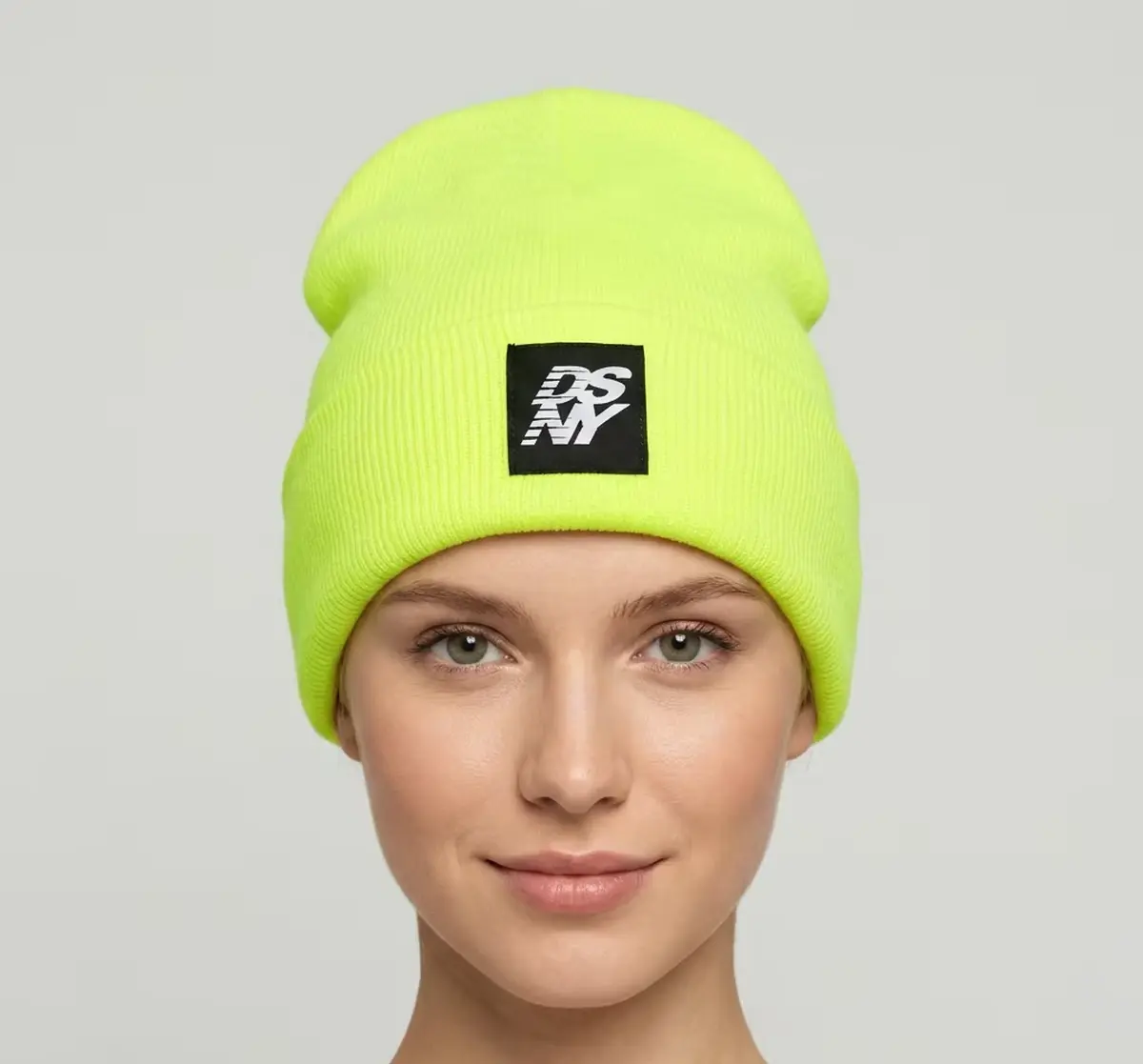 Bright green rib-knit beanie shown on a mannequin.
