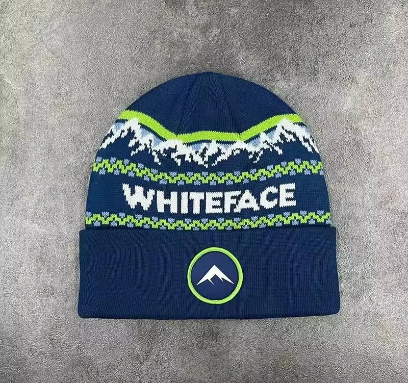 Navy ribbed beanie with white knitted lettering and lime patterned bands