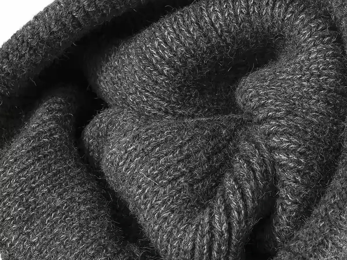 Close view of dark knit stitches and yarn texture