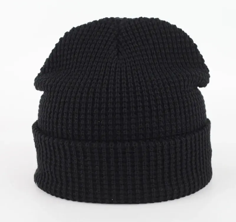 Black ribbed beanie showing the crown, rib knit and folded cuff