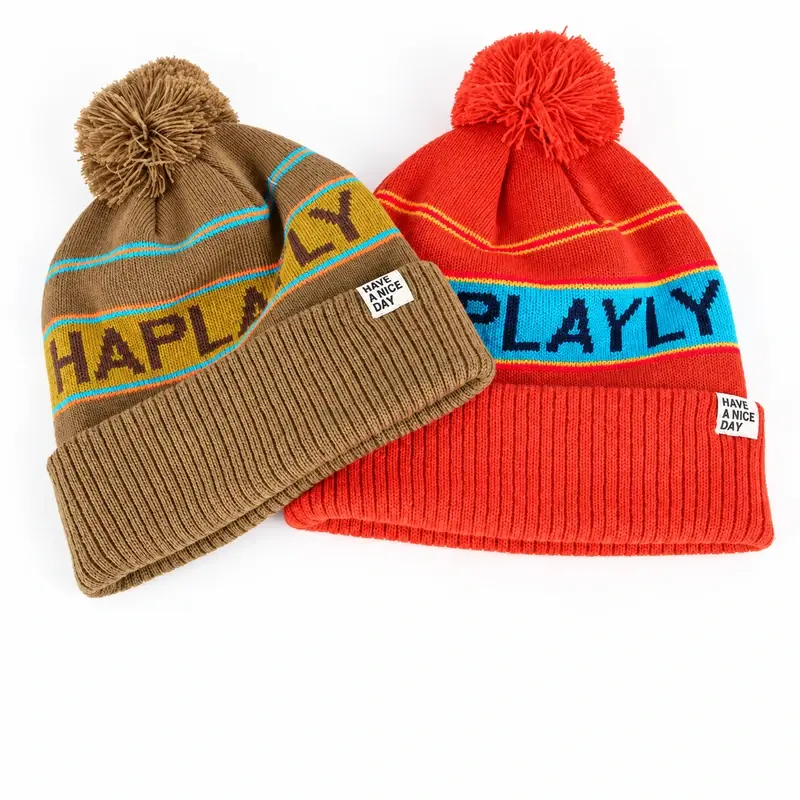 Two striped pom-pom beanies in tan and red colorways