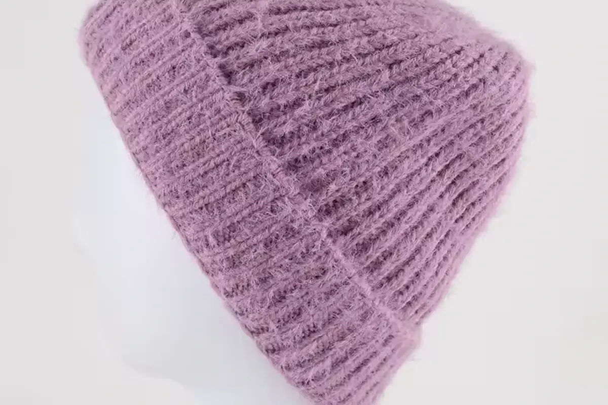 Close view of lavender chunky cable-knit beanie texture
