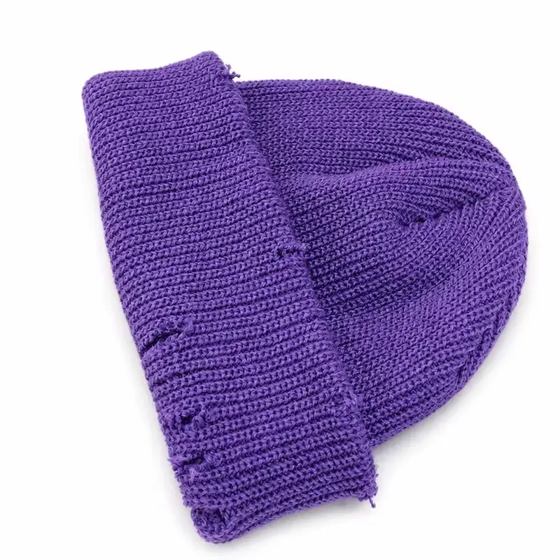 Purple oversized knit beanie laid flat with its crown draped back