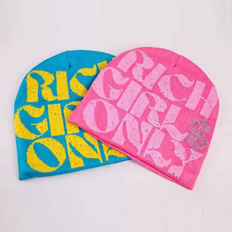 Blue and pink cuffless knit beanies shown side by side