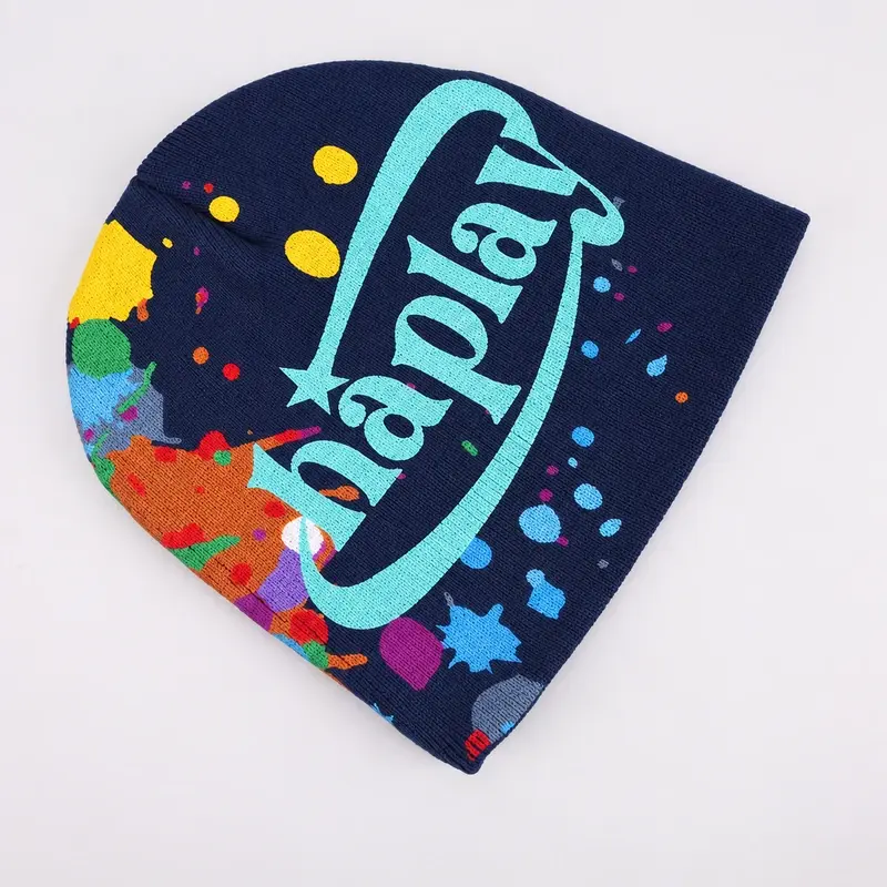 Navy cuffless knit beanie showing its lower edge and multicolor front knit detail