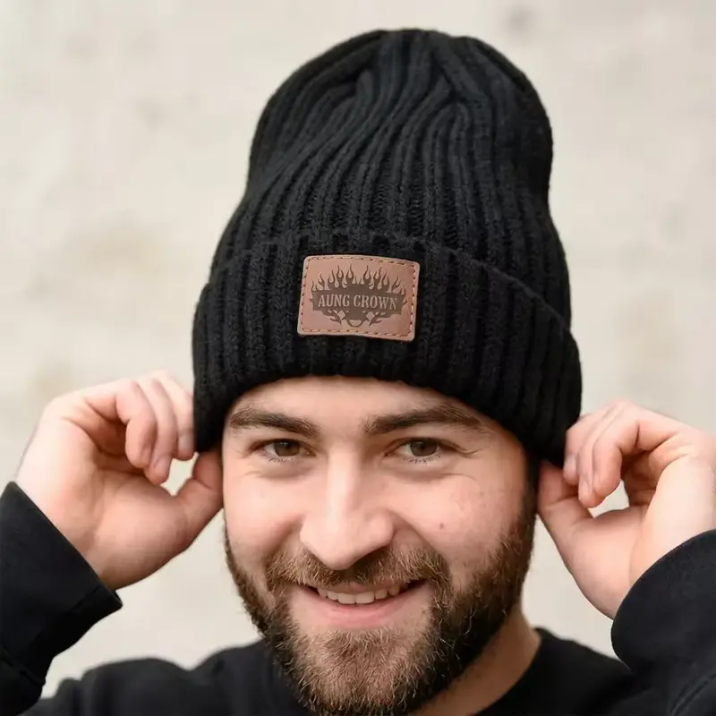 Person adjusting the lower edge of a black knit beanie