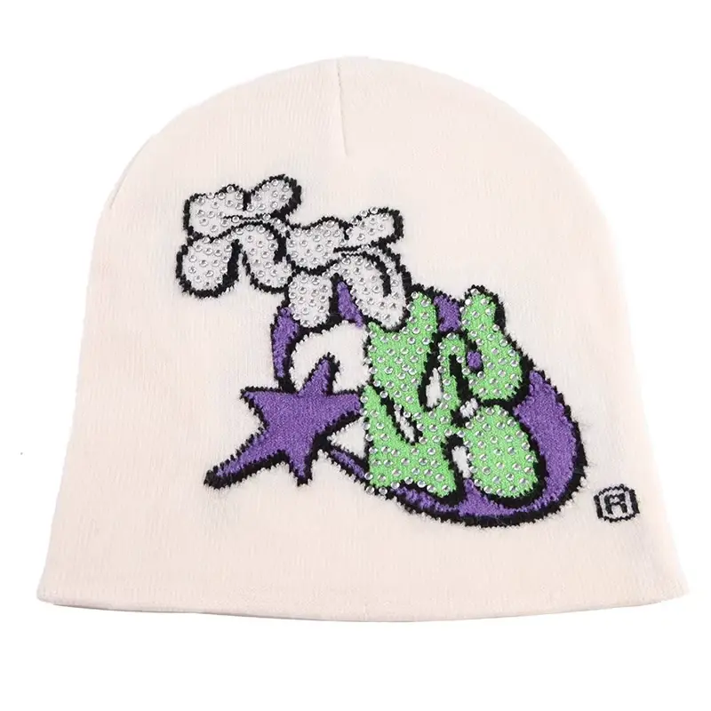 Cream cuffless knit beanie with colorful embroidered front motif