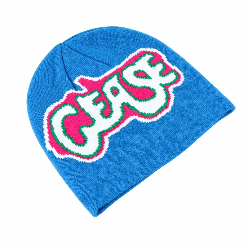 Blue cuffless knit beanie with a white outlined multicolor front motif