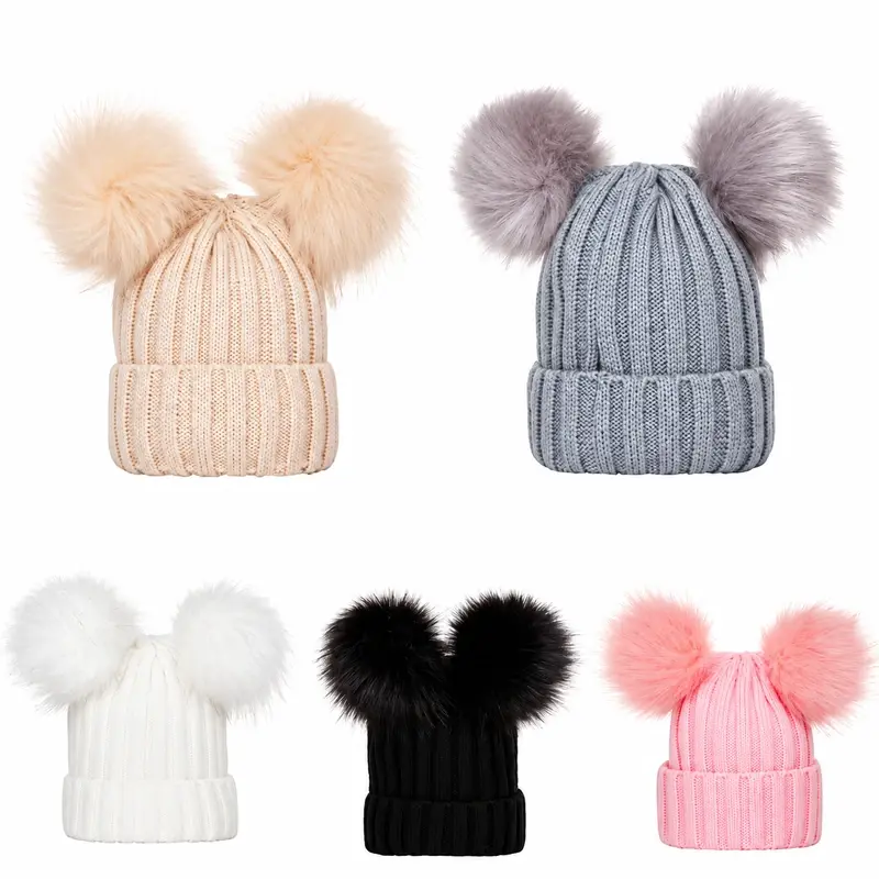 Five rib-knit beanies showing paired pom-pom attachment positions in several colors
