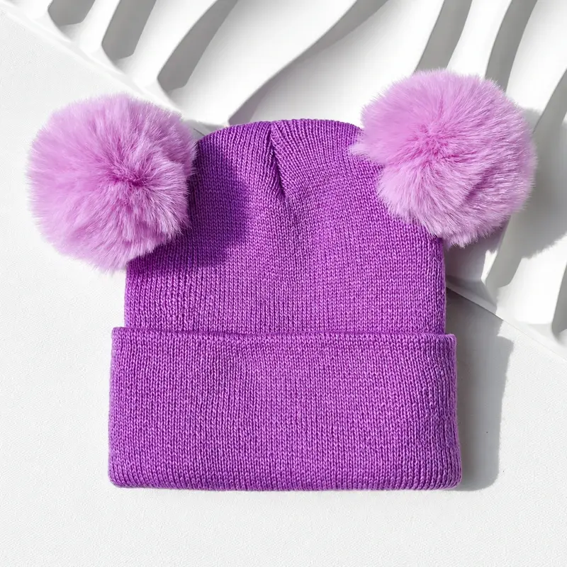 Purple rib-knit beanie with two pink pom-poms and a folded cuff