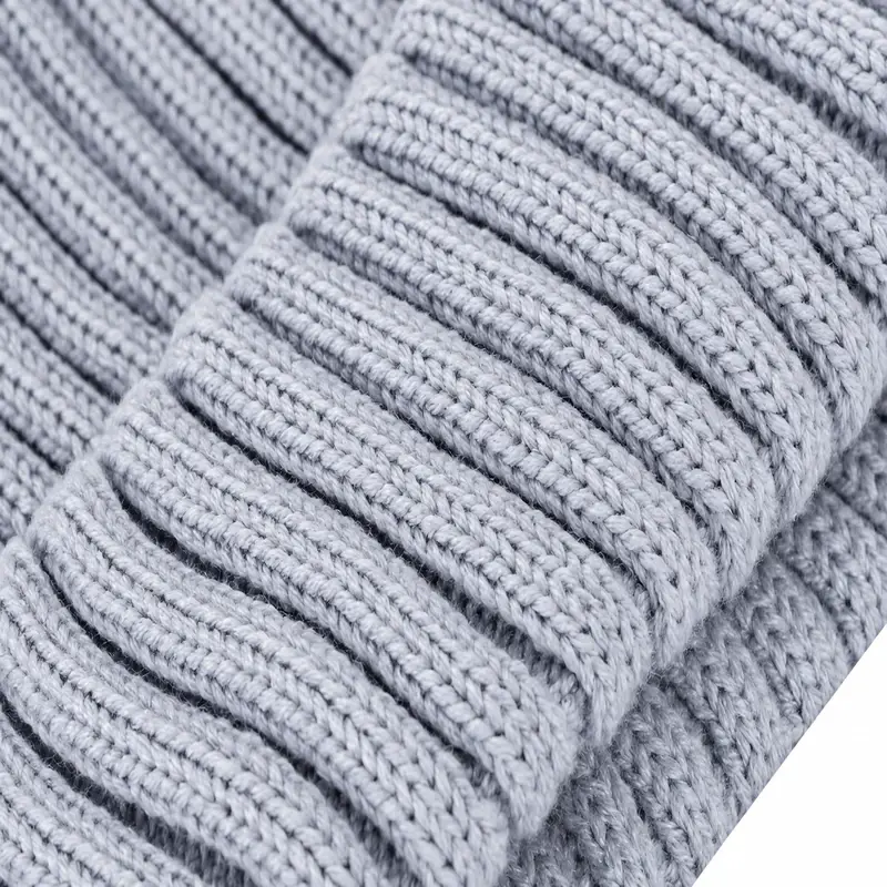 Macro close-up of pale gray-blue rib-knit beanie yarn