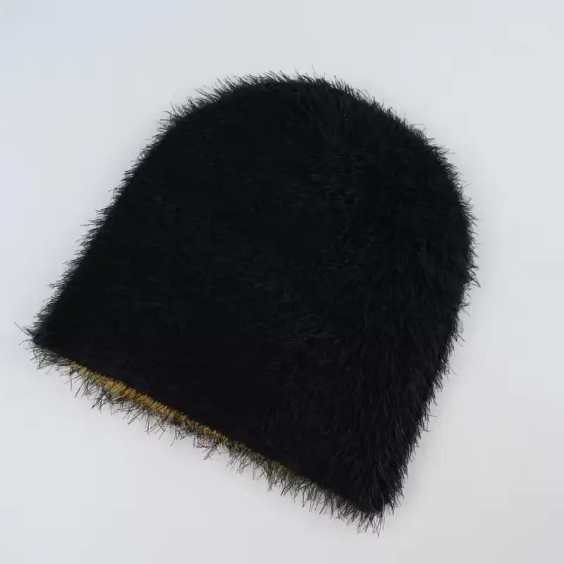 Back view of a black fuzzy winter beanie