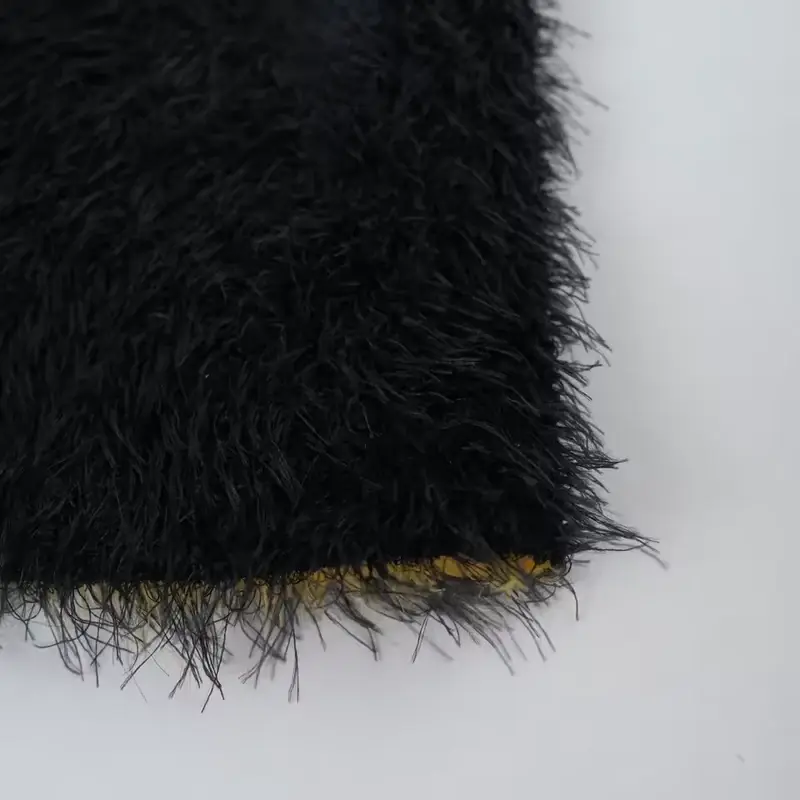 Close-up of black fuzzy beanie fabric and edge finish