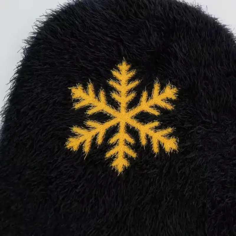 Yellow snowflake embroidery on a black knit beanie