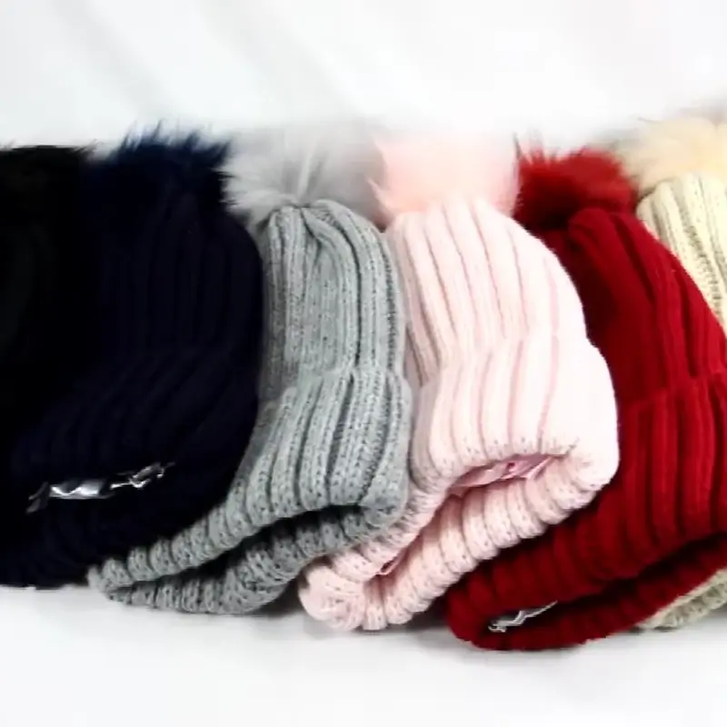 Ribbed pom beanies arranged in different colors