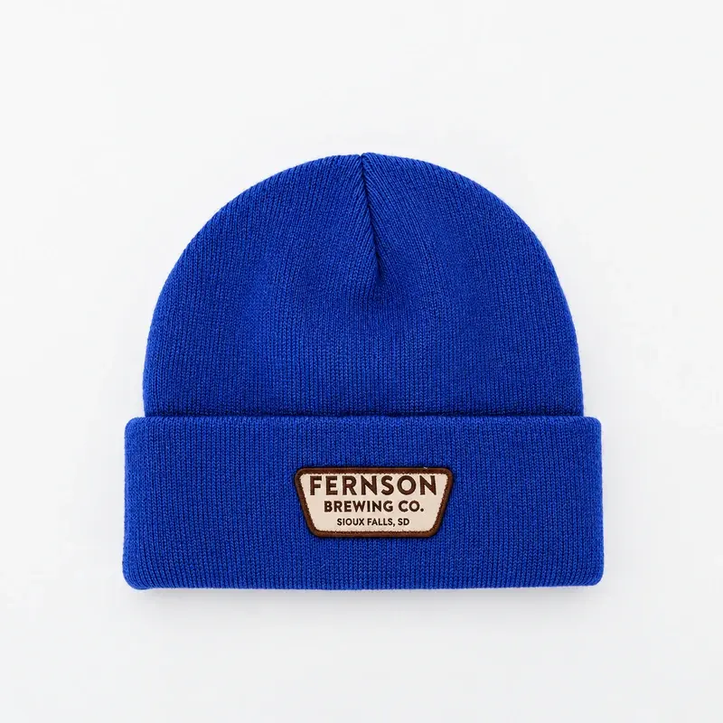 Blue short cuffed beanie with a sewn front patch