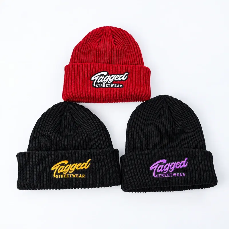 Three red and black short beanies with embroidered cuff logos