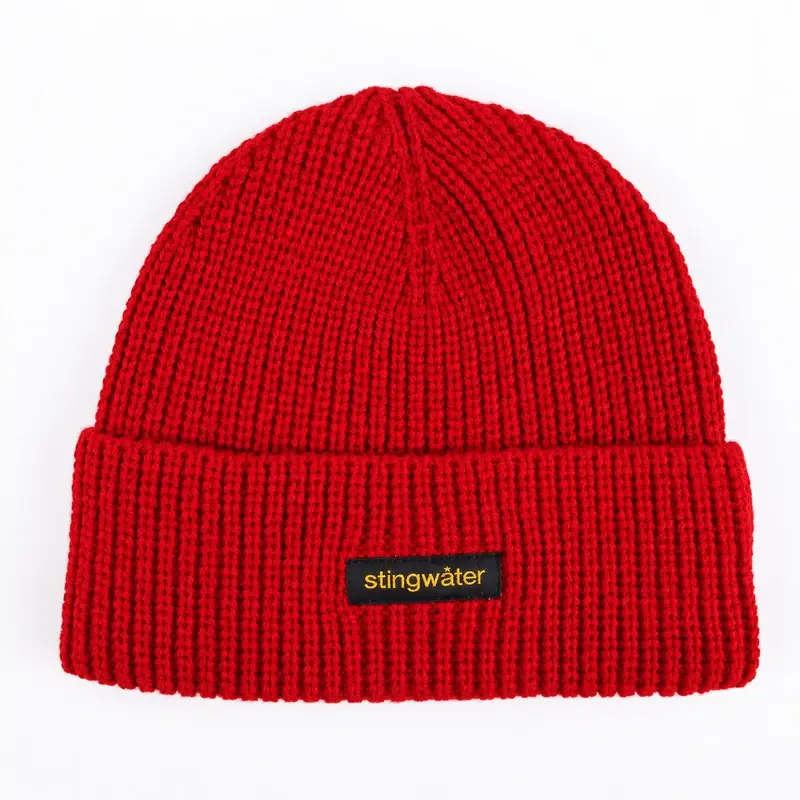 Red short beanie showing an embroidered patch centered on the folded cuff