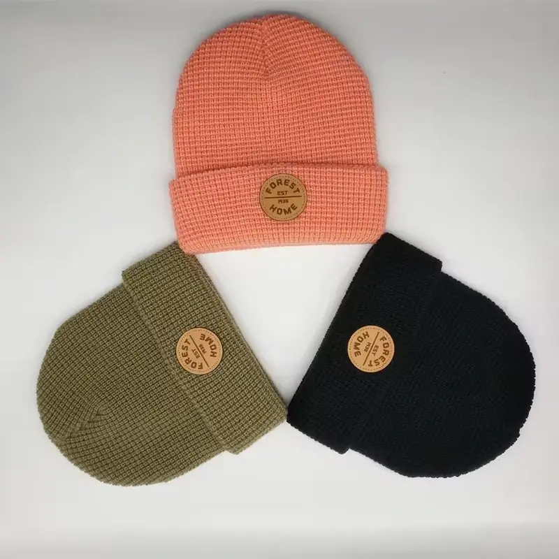 Coral, olive and black cuffed beanies with a raised waffle knit texture
