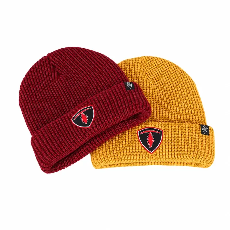 Wine red and mustard folded-cuff beanies with shield-shaped sewn patches