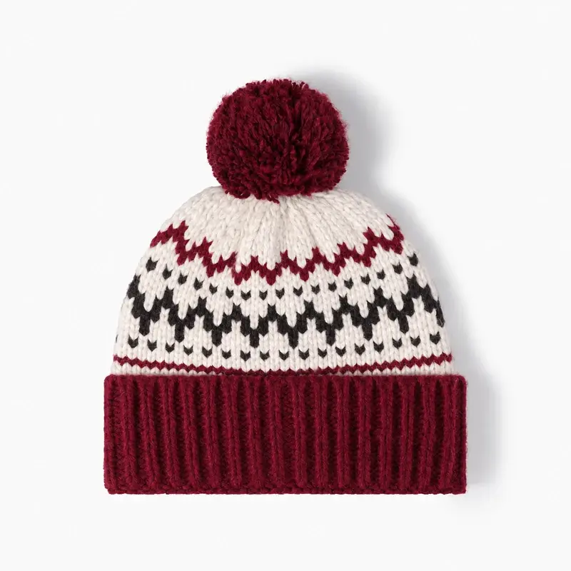 Red and white Nordic snowflake pom pom beanie with burgundy cuff