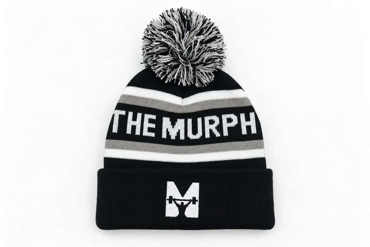 Branded knit beanie showing cuff logo and faux fur pom