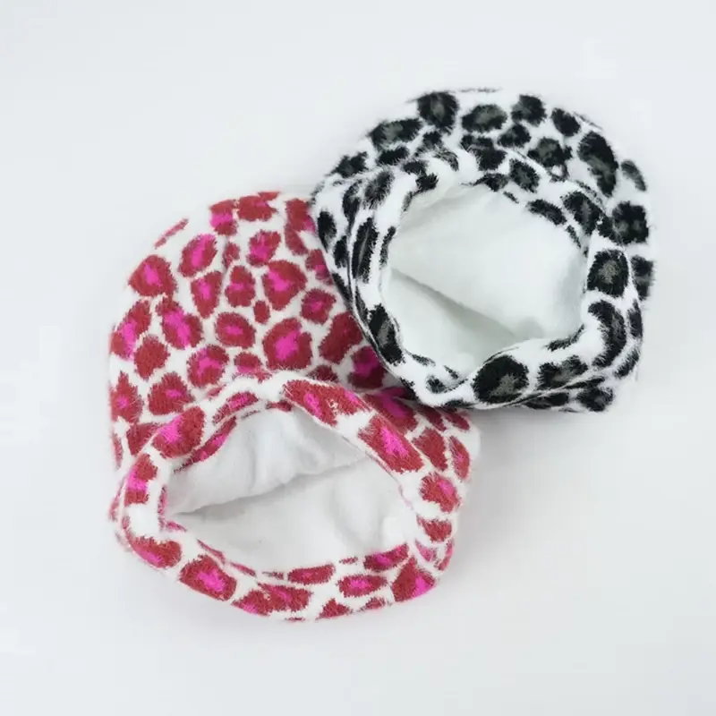Two patterned beanies turned to show their white fleece lining