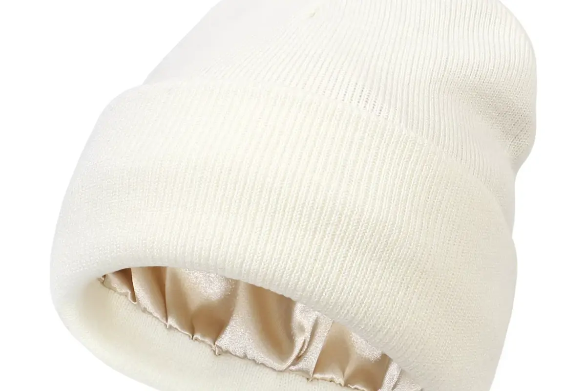 White cuffed beanie with a pale fleece lining visible at the opening