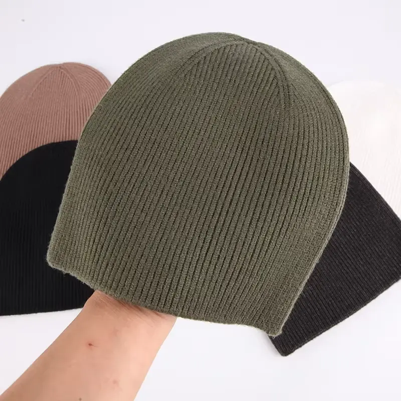 Olive rib-knit cuffless beanie worn on a model