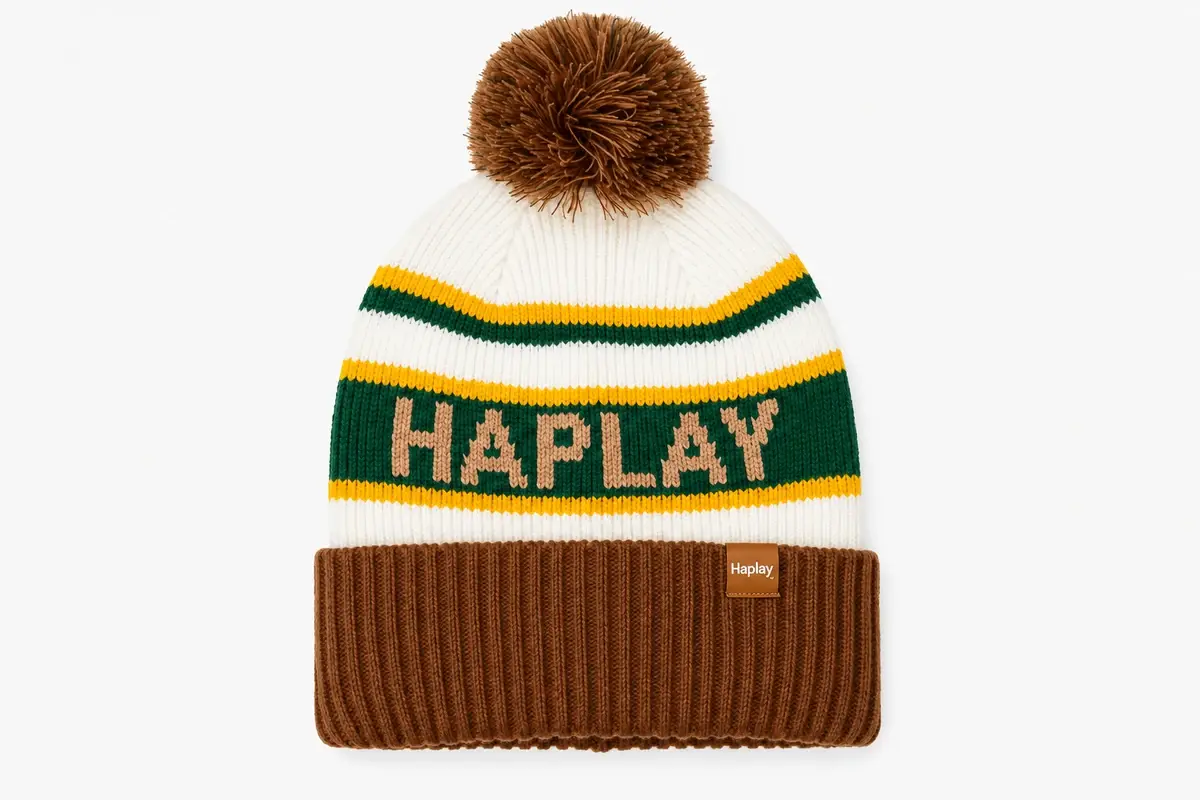 White pom pom jacquard beanie with deep green and yellow bands