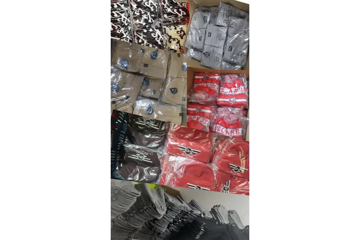 Packed knit hats in clear bags stacked for shipment