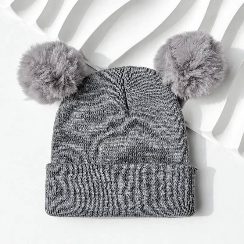 Gray double pom pom knit beanie with a cuffed rib-knit brim