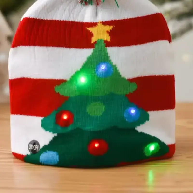 Close-up of the knitted Christmas tree and glowing lights on the LED beanie