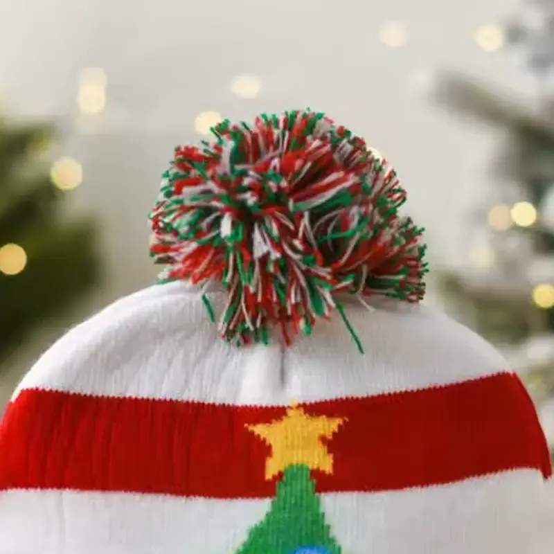 Red, green and white yarn pom on the LED Christmas beanie