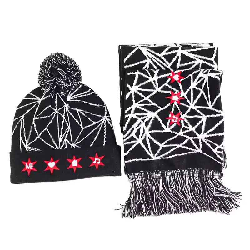 Red pom-pom beanie beside a black-and-white knitted scarf with red star motifs