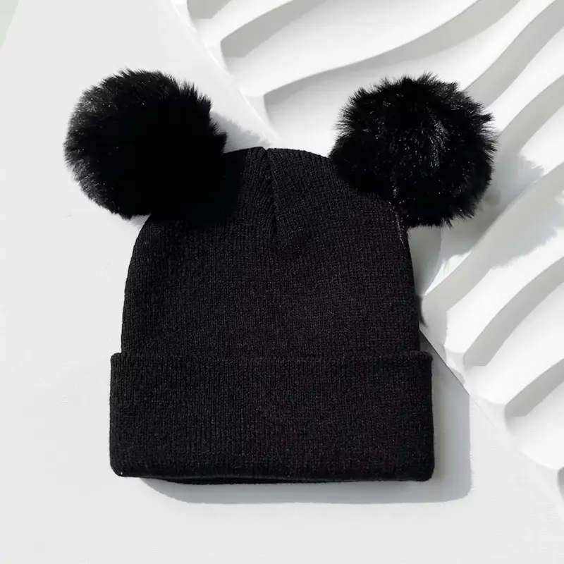 Black knit beanie with two black pom poms
