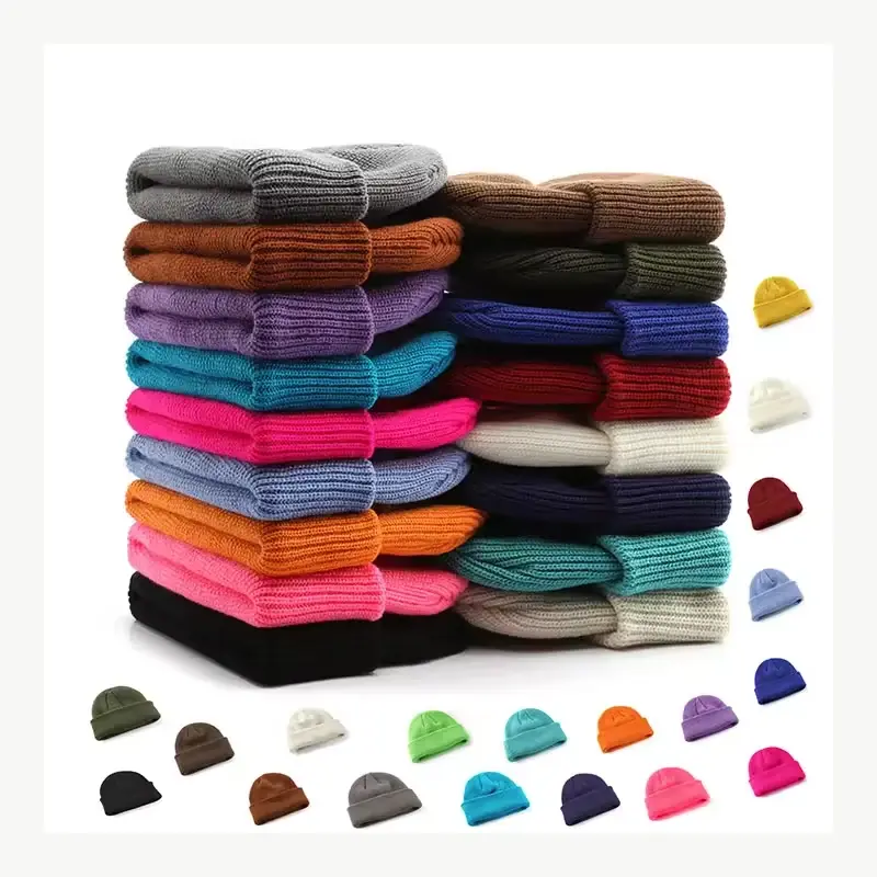 Stack of knit beanies in multiple colors and constructions