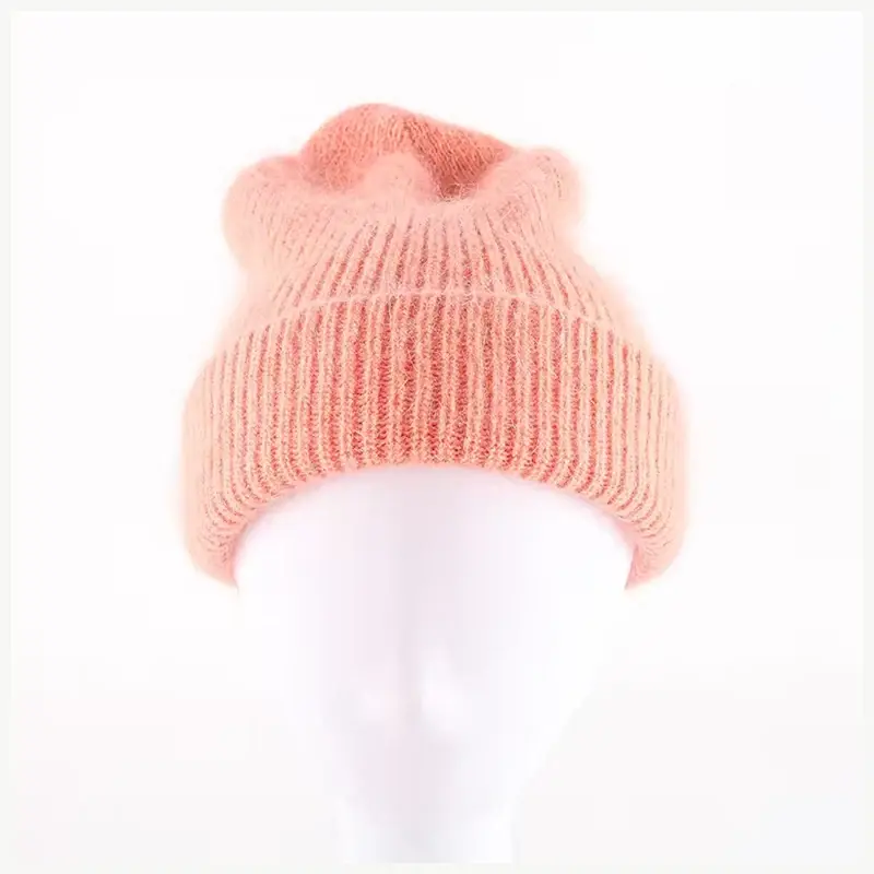 Peach pink slouchy knit beanie displayed on a mannequin