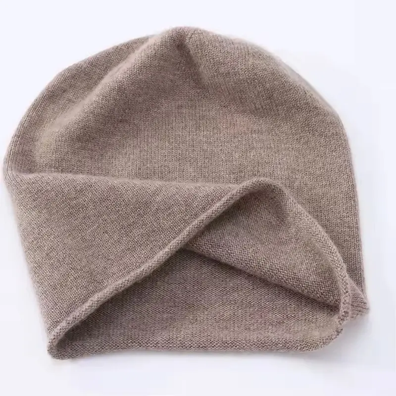 Taupe slouchy knit beanie folded to show its soft construction
