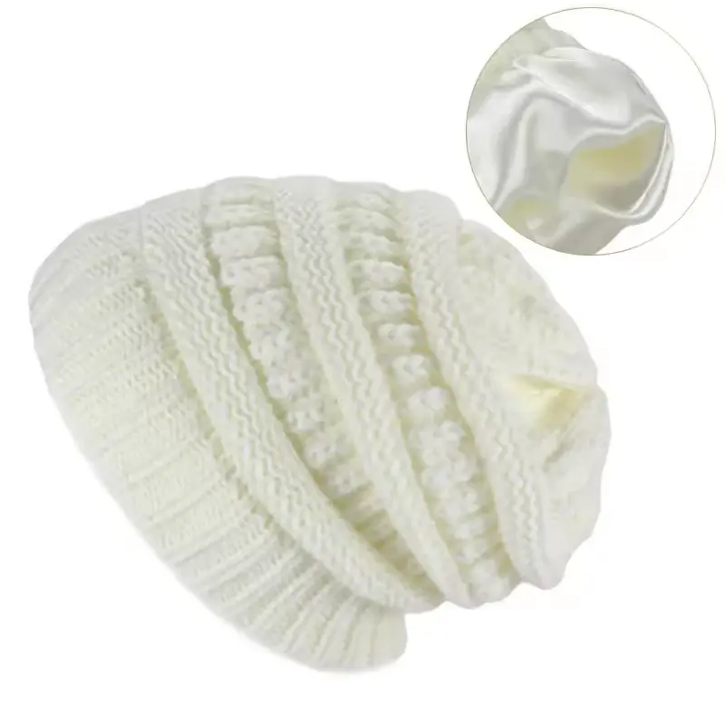Cream cable knit beanie with a relaxed crown