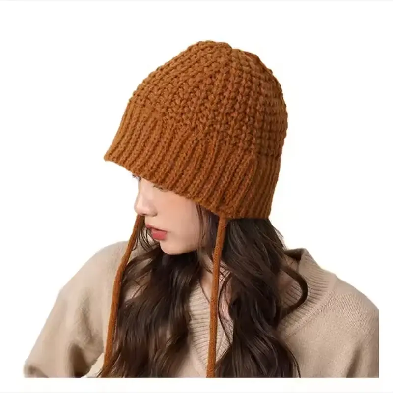 Brown chunky knit beanie worn with a relaxed crown