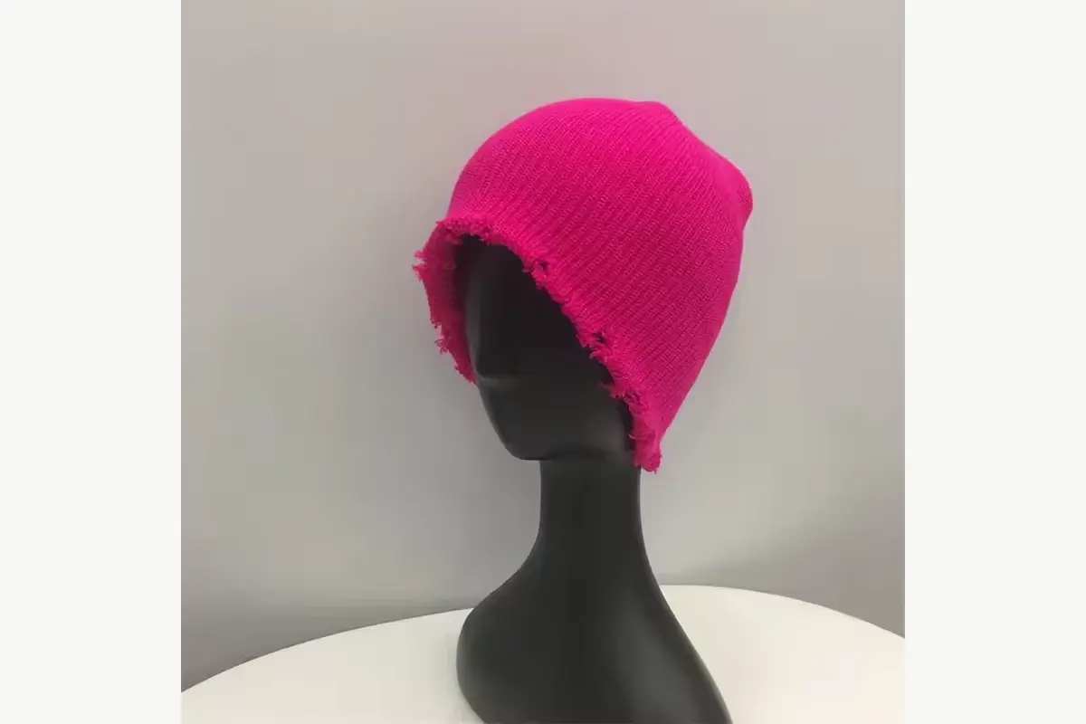 Side view of a pink extended-crown knit beanie