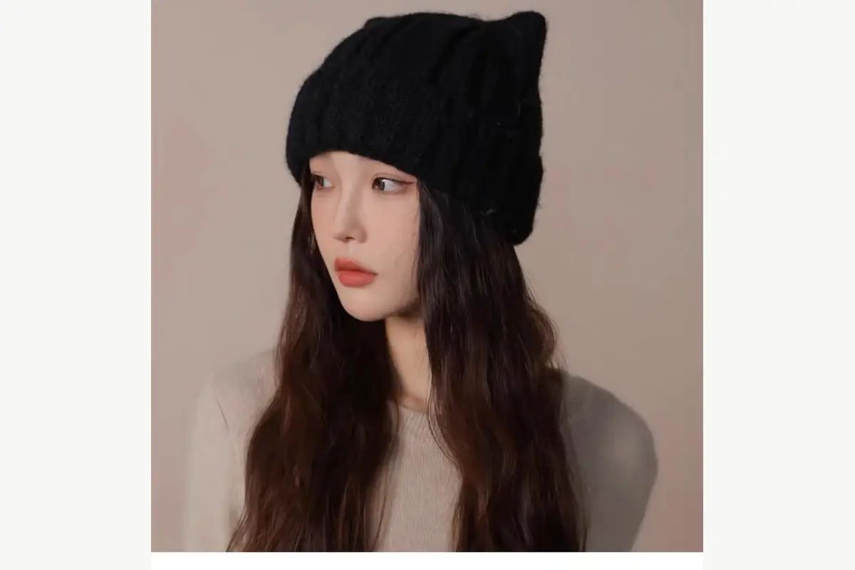 Black slouchy knit beanie shown on a model from the side