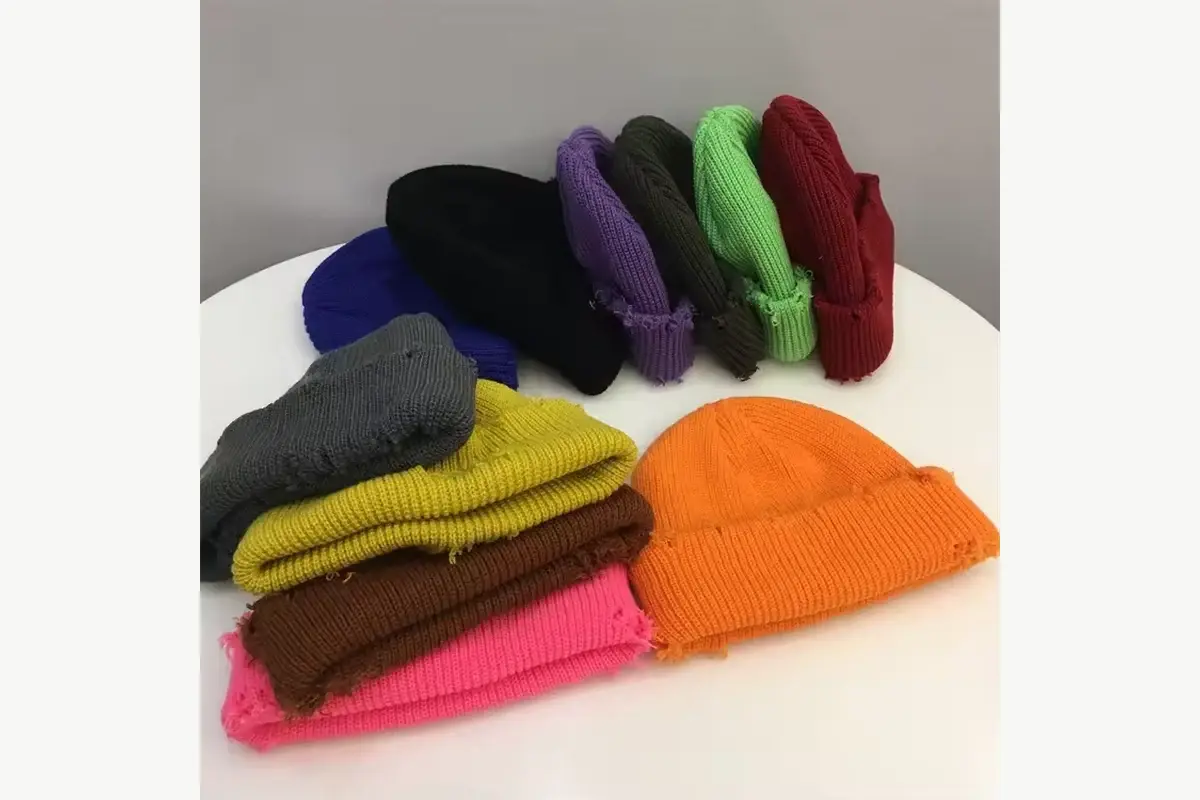 Bright solid-color beanies arranged in several yarn shades