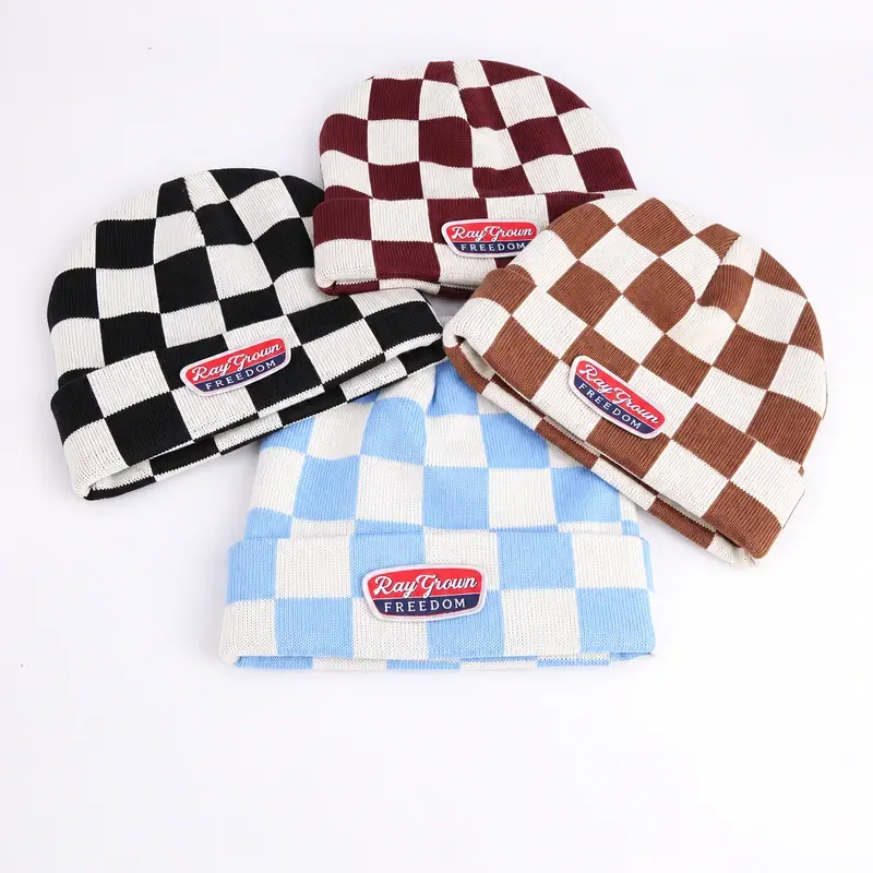 Four short fisherman beanies with checkerboard knits and woven patches