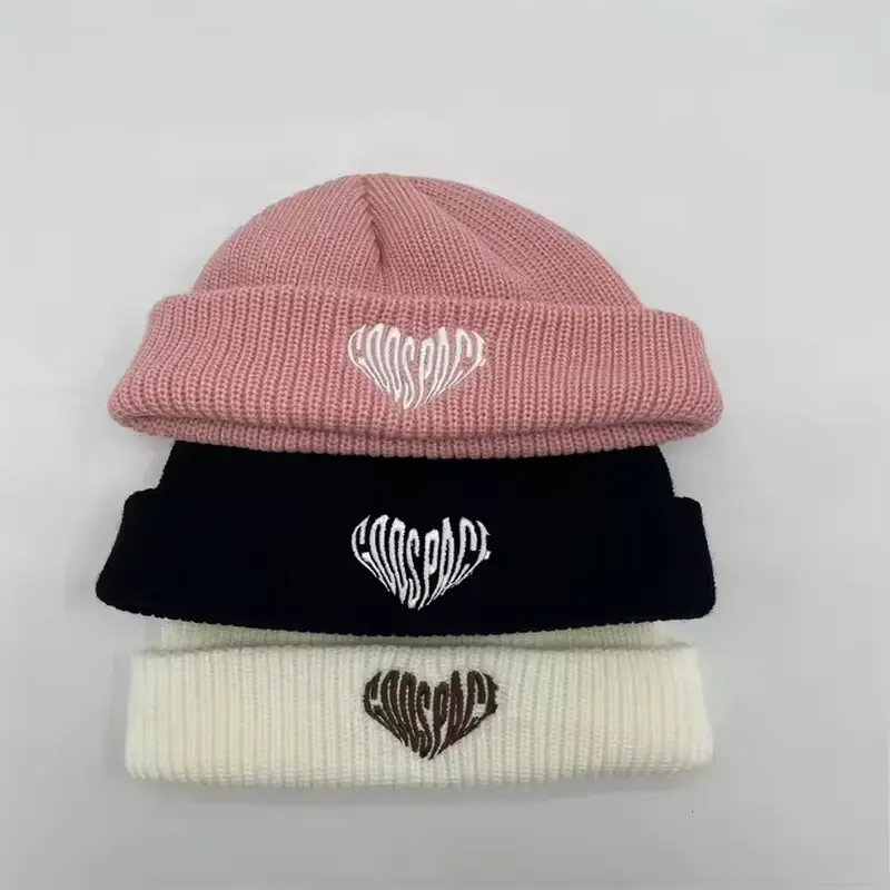 Three short cuffed beanies with stitched heart emblems